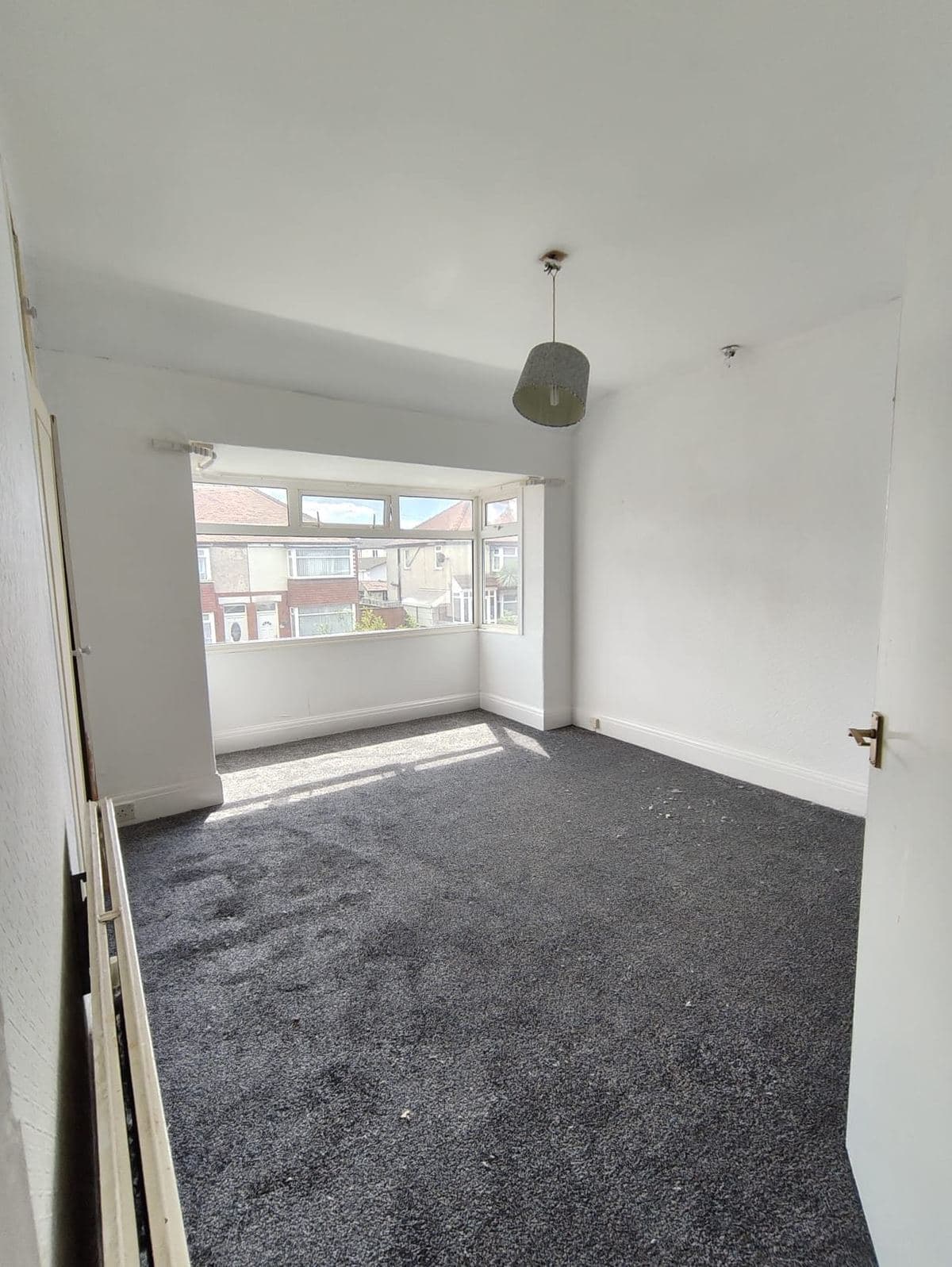 A finished bedroom at Bart's property after renovation, with fresh carpet and decoration