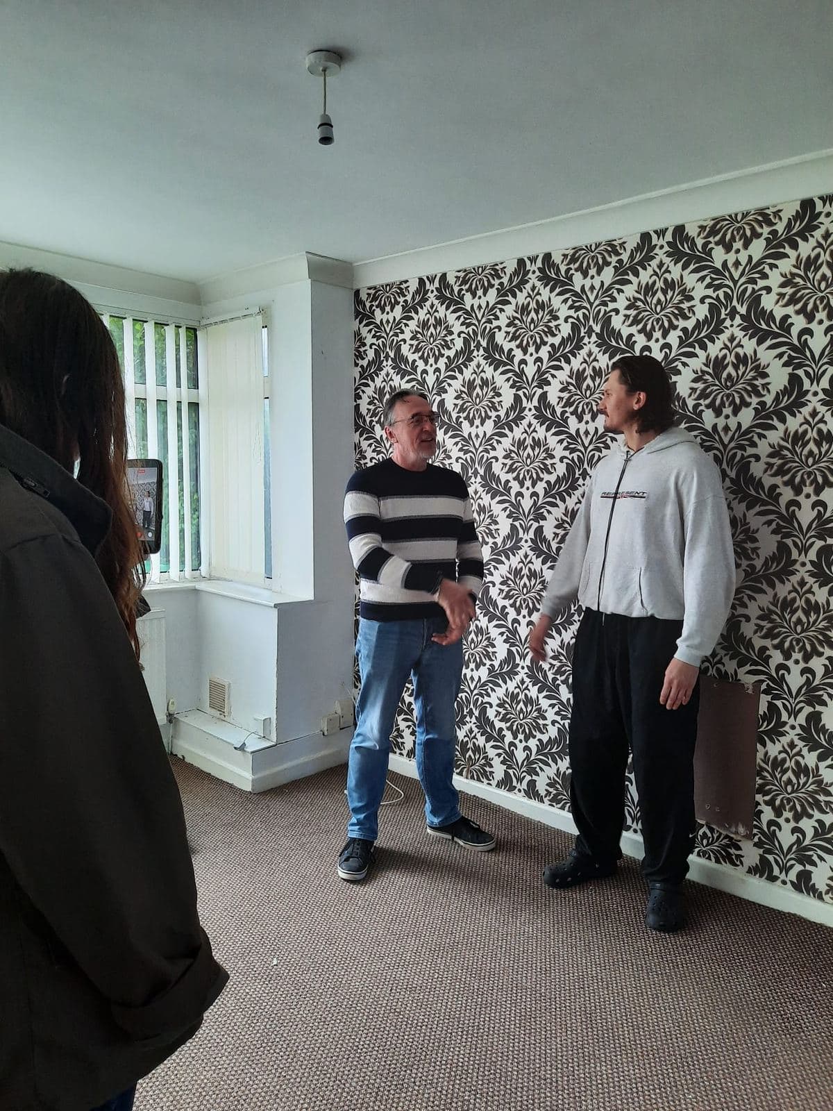 Steve walking Bart through the empty property before renovation began
