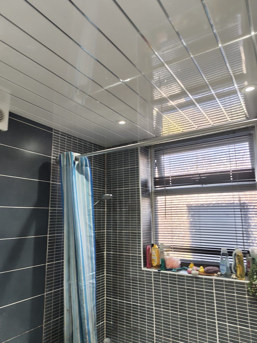 Wide shot of finished bathroom, ceiling, tiling, and extractor fan all confirmed clear