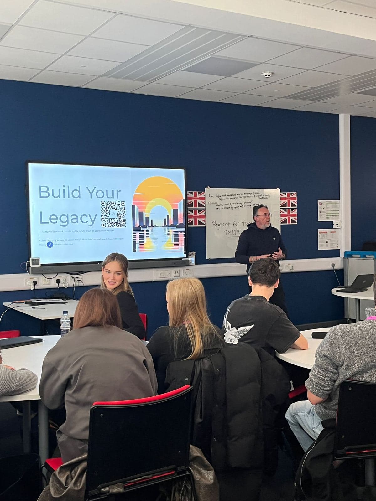 Steve Potter presenting to a college class, with a 'Build Your Legacy' slide on screen